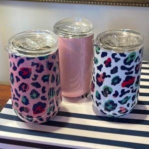 A set of three cups with lids